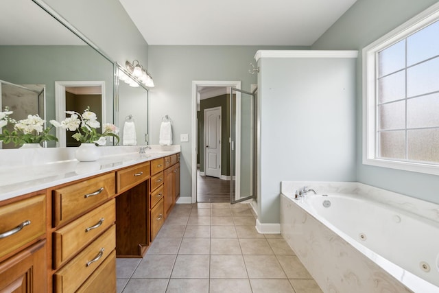 bathroom with a stall shower, baseboards, tile patterned flooring, a tub with jets, and vanity