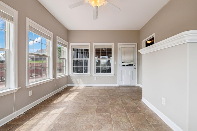unfurnished sunroom with baseboards
