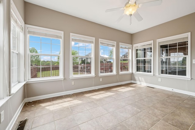 unfurnished sunroom with visible vents, tile patterned floors, and baseboards