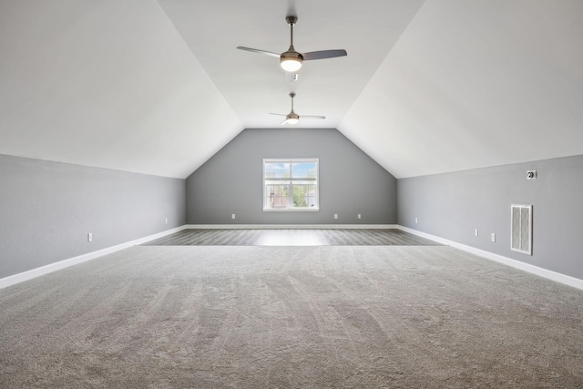 additional living space with carpet, visible vents, lofted ceiling, and baseboards