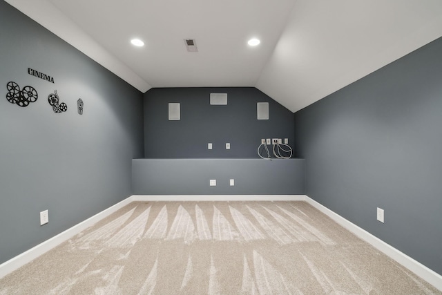 additional living space featuring carpet, visible vents, lofted ceiling, and baseboards
