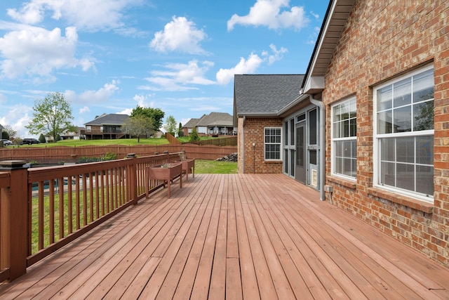 deck with a residential view and a fenced backyard