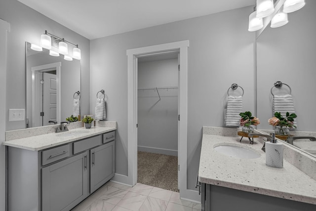 558 Twyla Dr, Lebanon, TN 37087 - bathroom featuring two vanities, a spacious closet, and marble look tile flooring