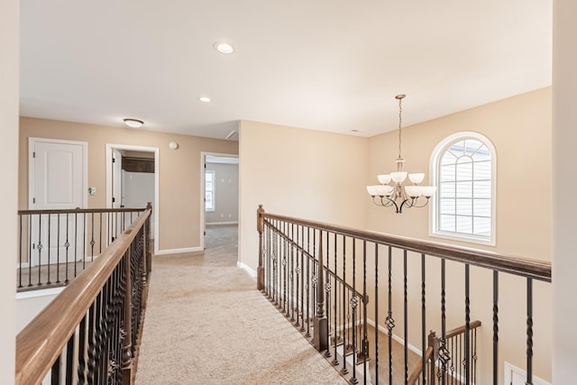 133 Kildeer Dr, Clarksville, TN 37040 - hall with carpet, an upstairs landing, a chandelier, and baseboards