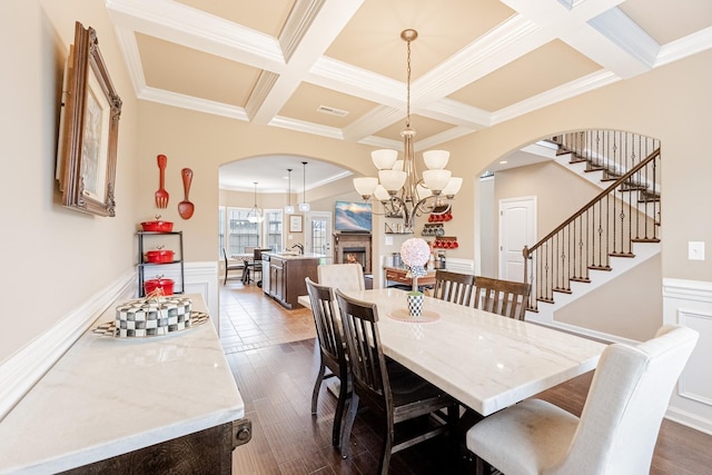 133 Kildeer Dr, Clarksville, TN 37040 - dining room featuring arched walkways, ornamental molding, a chandelier, beam ceiling, and coffered ceiling
