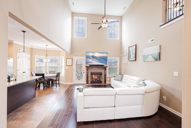 133 Kildeer Dr, Clarksville, TN 37040 - living room featuring a fireplace with flush hearth, dark wood-type flooring, baseboards, and a ceiling fan