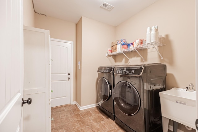 133 Kildeer Dr, Clarksville, TN 37040 - washroom featuring laundry area, separate washer and dryer, visible vents, a sink, and baseboards