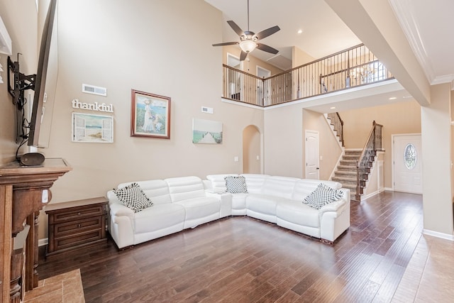 133 Kildeer Dr, Clarksville, TN 37040 - living area featuring a towering ceiling, stairway, a ceiling fan, arched walkways, and hardwood / wood-style flooring