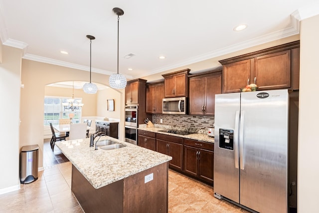 133 Kildeer Dr, Clarksville, TN 37040 - kitchen featuring crown molding, appliances with stainless steel finishes, a kitchen island with sink, a sink, and decorative backsplash