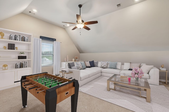 playroom featuring visible vents, light colored carpet, vaulted ceiling, and a ceiling fan