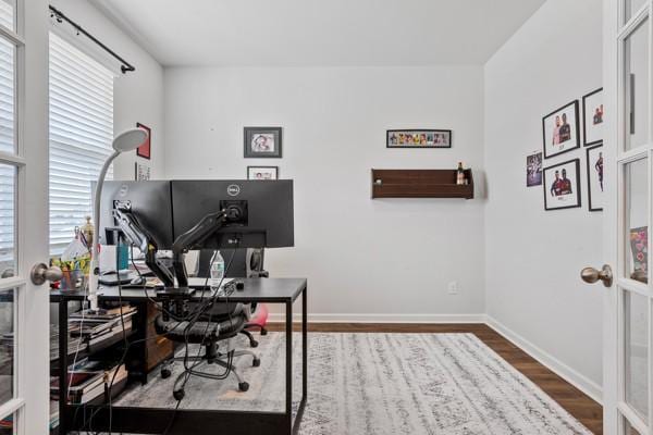 home office with wood finished floors and baseboards