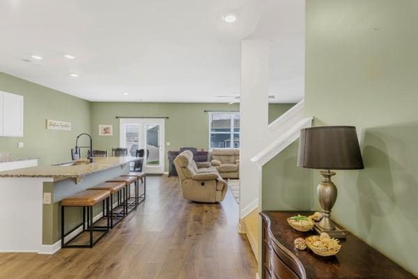 living room featuring recessed lighting, wood finished floors, and baseboards