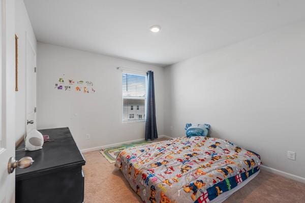 bedroom with carpet floors and baseboards