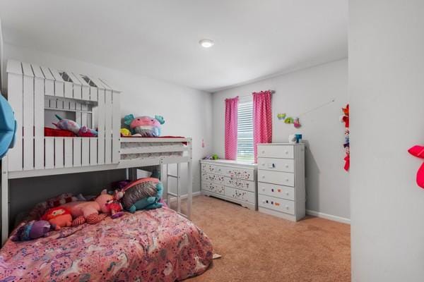 carpeted bedroom featuring baseboards
