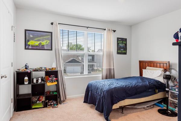 bedroom featuring baseboards and carpet floors