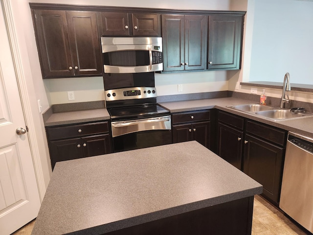kitchen with a sink, appliances with stainless steel finishes, and dark brown cabinets