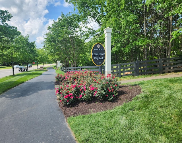 surrounding community featuring fence and a yard