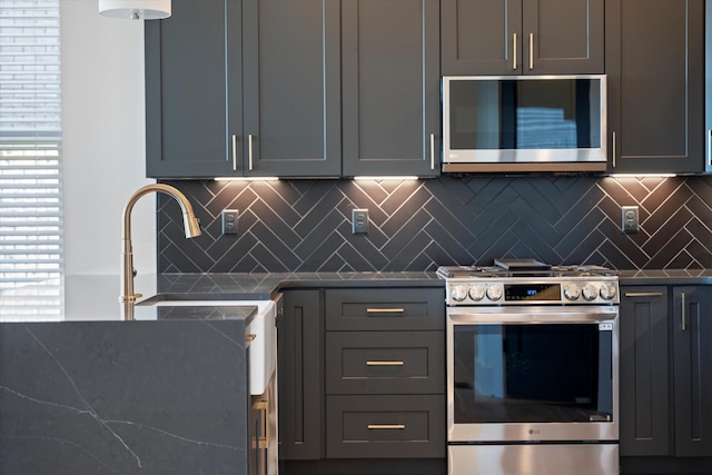 416 Mercomatic Dr, Nashville, TN 37209 - kitchen with a healthy amount of sunlight, a sink, stainless steel range with electric cooktop, and decorative backsplash