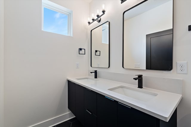 416 Mercomatic Dr, Nashville, TN 37209 - bathroom with double vanity, a sink, tile patterned flooring, and baseboards