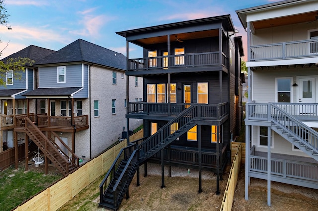 416 Mercomatic Dr, Nashville, TN 37209 - back of house at dusk featuring fence and stairs