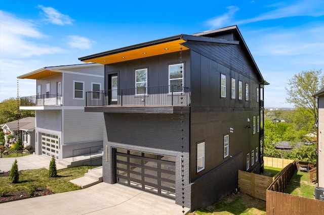 416 Mercomatic Dr, Nashville, TN 37209 - view of front of home with an attached garage, driveway, fence, and a balcony