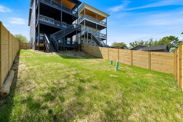 416 Mercomatic Dr, Nashville, TN 37209 - back of house featuring a fenced backyard, stairway, and a lawn