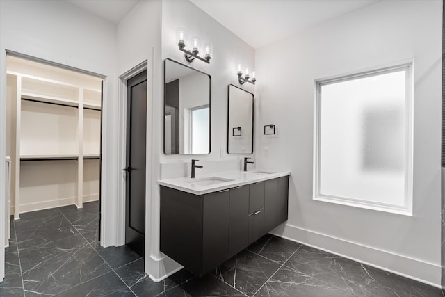 416 Mercomatic Dr, Nashville, TN 37209 - bathroom featuring baseboards, double vanity, marble finish floor, and a sink