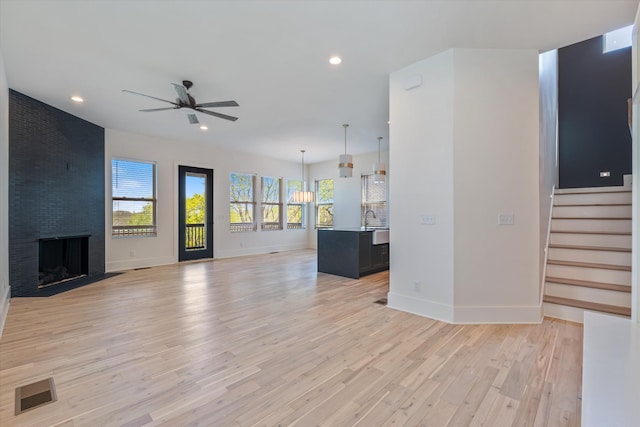 416 Mercomatic Dr, Nashville, TN 37209 - unfurnished living room with light wood-style flooring, a ceiling fan, visible vents, recessed lighting, and baseboards