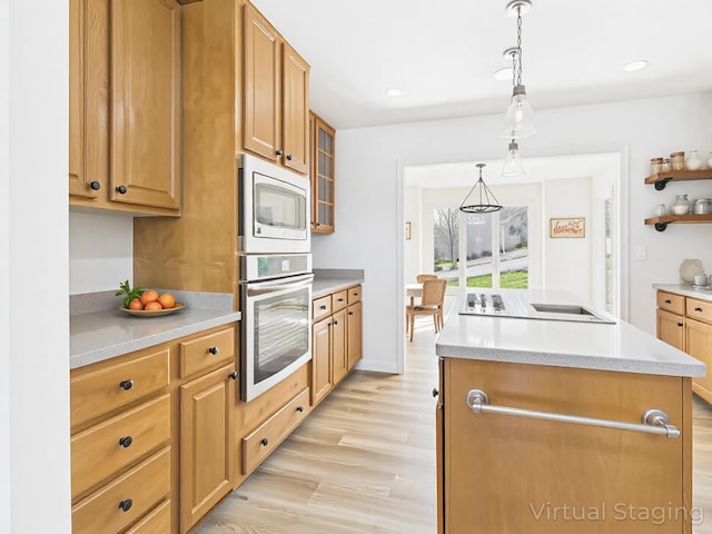 250 Sun Hill Cir, Cadiz, KY 42211 - kitchen featuring decorative light fixtures, light countertops, appliances with stainless steel finishes, light wood-style floors, and a center island with sink