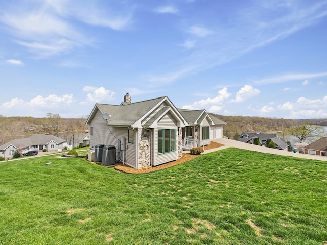 250 Sun Hill Cir, Cadiz, KY 42211 - rear view of property with concrete driveway, a yard, central AC, and a chimney
