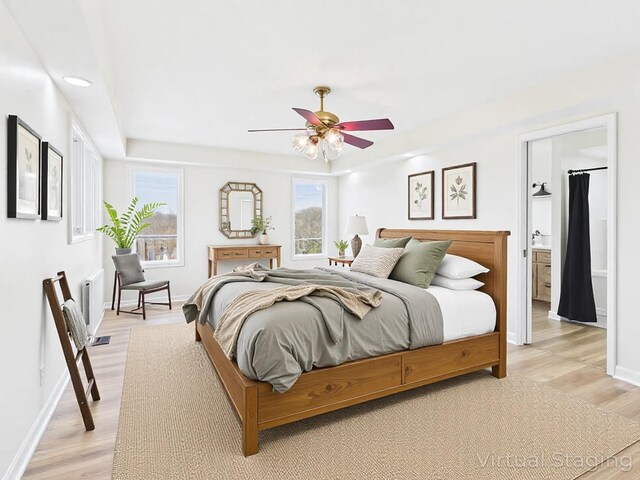 250 Sun Hill Cir, Cadiz, KY 42211 - bedroom featuring light wood-type flooring, baseboards, connected bathroom, a tray ceiling, and ceiling fan