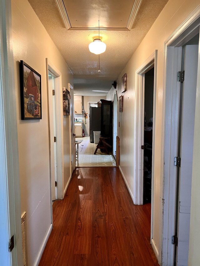1112 Cumberland St, Decherd, TN 37324 - hall featuring visible vents, attic access, baseboards, and wood finished floors
