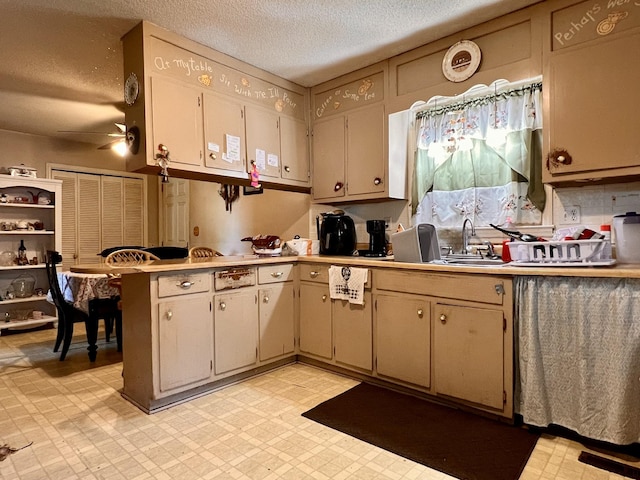 1112 Cumberland St, Decherd, TN 37324 - kitchen featuring light floors, a peninsula, light countertops, and a textured ceiling