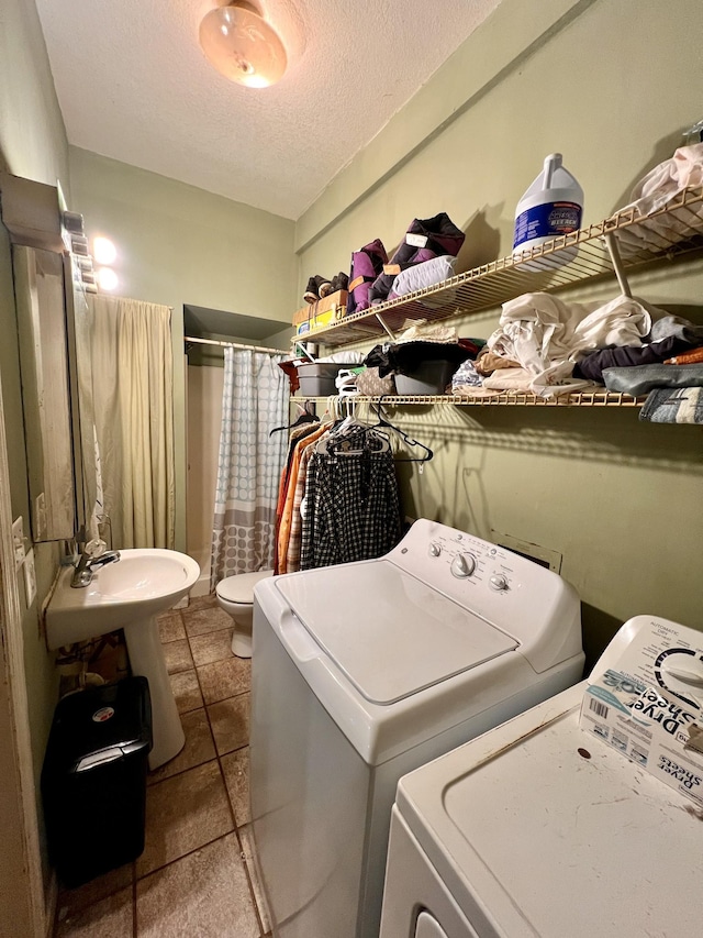 1112 Cumberland St, Decherd, TN 37324 - laundry room with a textured ceiling, washing machine and clothes dryer, a sink, and laundry area