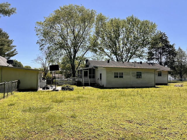 1112 Cumberland St, Decherd, TN 37324 - back of property with fence, a sunroom, and a yard