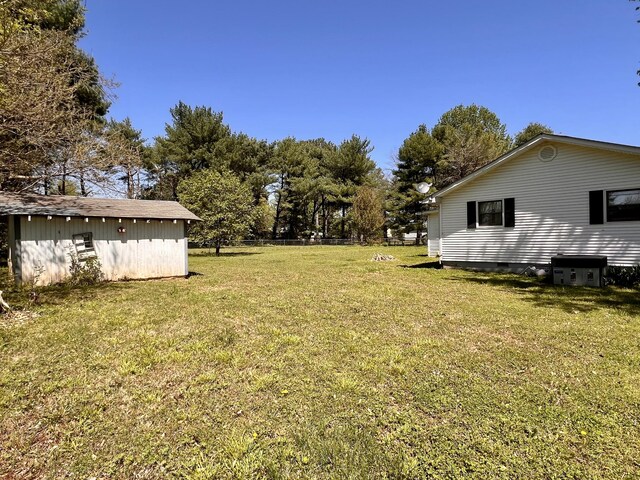 1112 Cumberland St, Decherd, TN 37324 - view of yard with central AC unit, fence, and an outbuilding