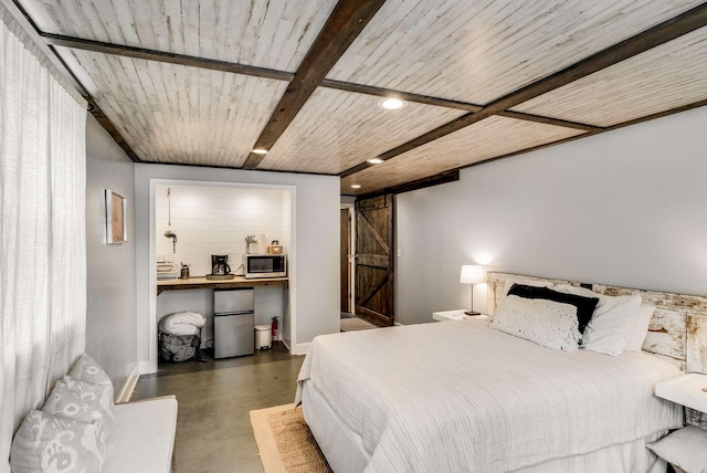 1001 N Graycroft Ave, Madison, TN 37115 - bedroom featuring baseboards, recessed lighting, freestanding refrigerator, a barn door, and finished concrete floors
