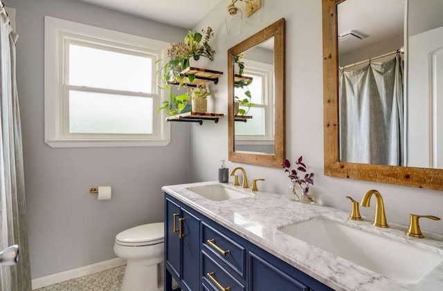 1001 N Graycroft Ave, Madison, TN 37115 - bathroom featuring double vanity, baseboards, a sink, and toilet