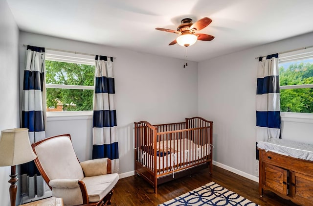 1001 N Graycroft Ave, Madison, TN 37115 - bedroom with a crib, ceiling fan, baseboards, and wood finished floors