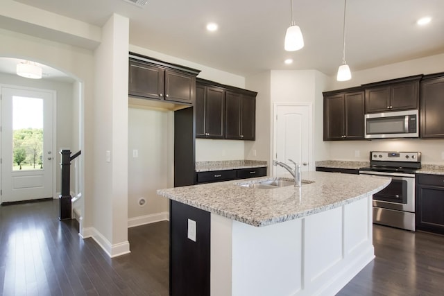 kitchen featuring a sink, appliances with stainless steel finishes, dark brown cabinetry, and dark wood-type flooring