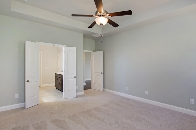 unfurnished bedroom featuring light colored carpet, baseboards, and a ceiling fan