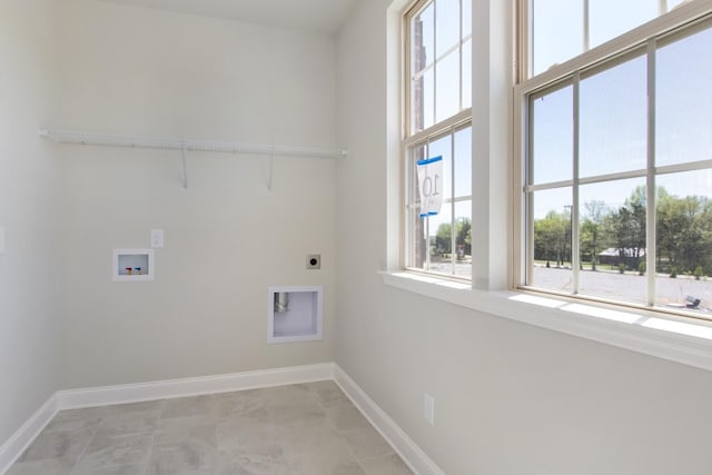 laundry room with baseboards, electric dryer hookup, laundry area, and a healthy amount of sunlight