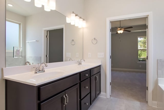 full bath featuring a sink, tile patterned floors, ceiling fan, and a bath