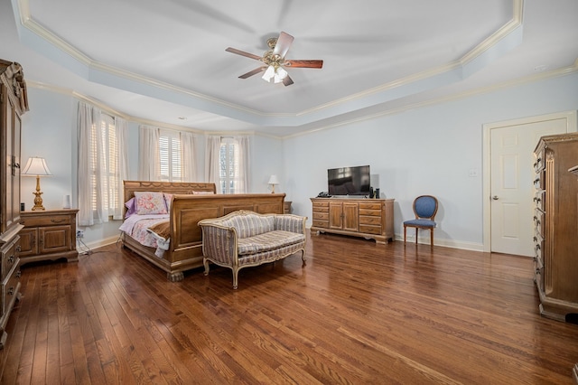 bedroom with baseboards, ceiling fan, dark wood finished floors, crown molding, and a tray ceiling