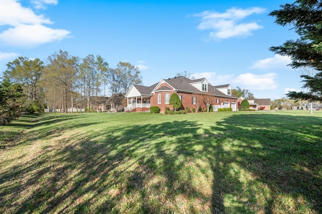 exterior space featuring a yard and brick siding