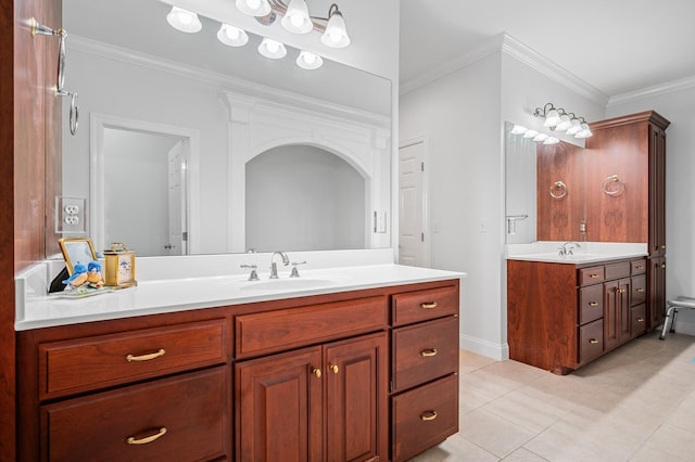 bathroom with a sink, two vanities, tile patterned flooring, and crown molding