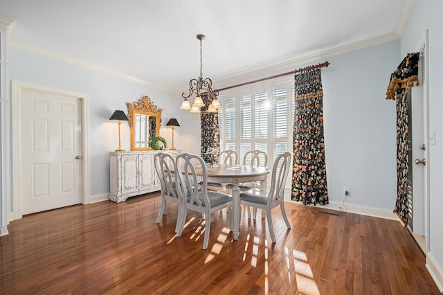dining area with visible vents, baseboards, a notable chandelier, crown molding, and wood finished floors