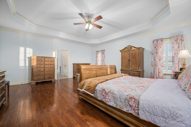 bedroom with baseboards, ornamental molding, a raised ceiling, hardwood / wood-style floors, and ceiling fan