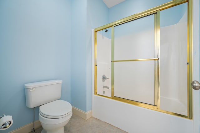 full bathroom with toilet, tile patterned floors, baseboards, and enclosed tub / shower combo