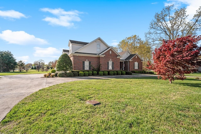 traditional-style house with brick siding and a front lawn